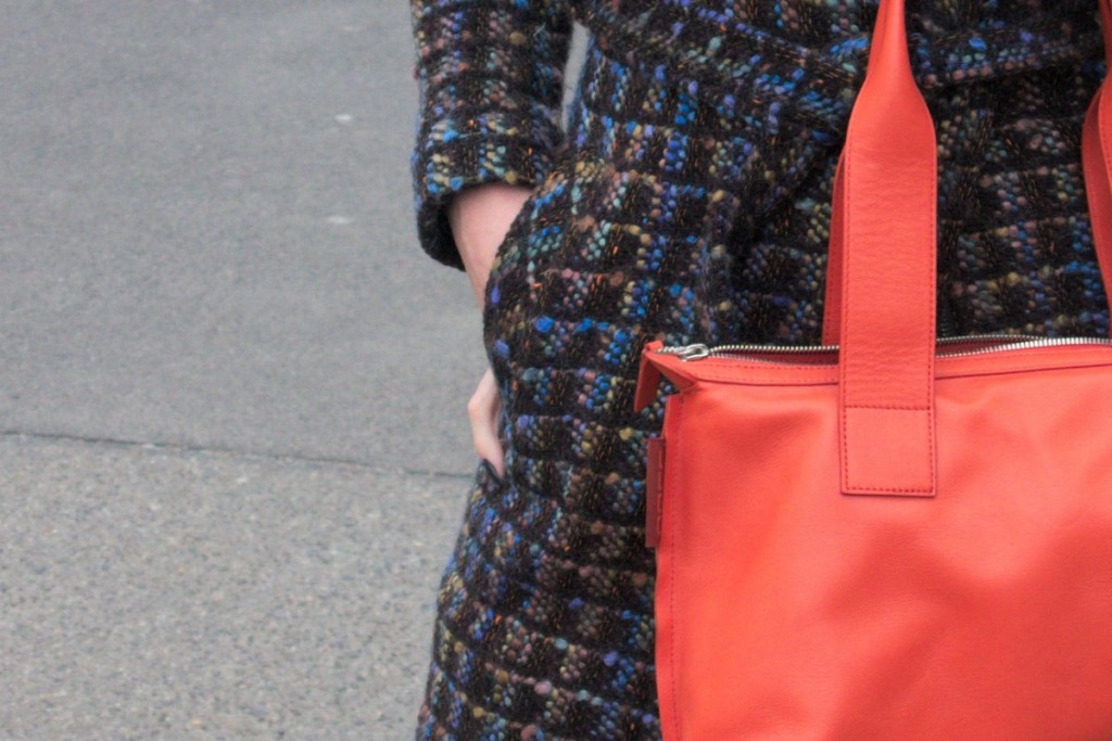 Blue and orange bouclé coat by moods of Norway and orange cow leather bag by Bree