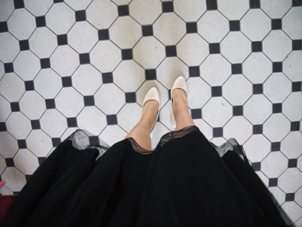 Black and white tiles and cream pumps