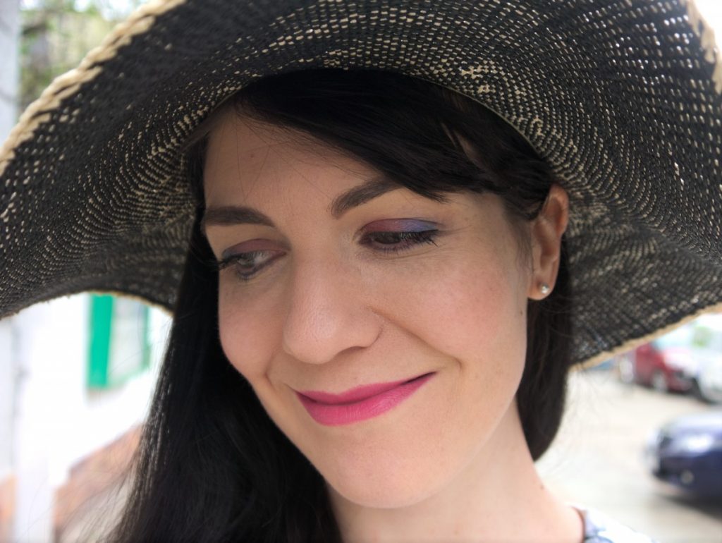 blue and pink eyeshadow and straw hat