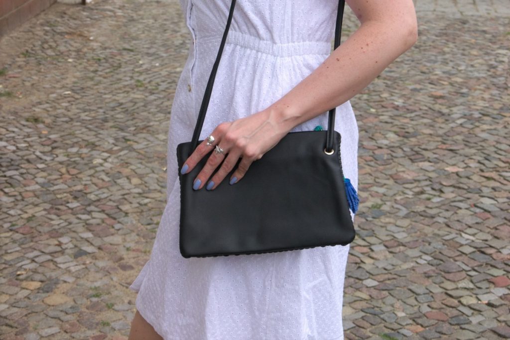 white cotton dress and tassel bag