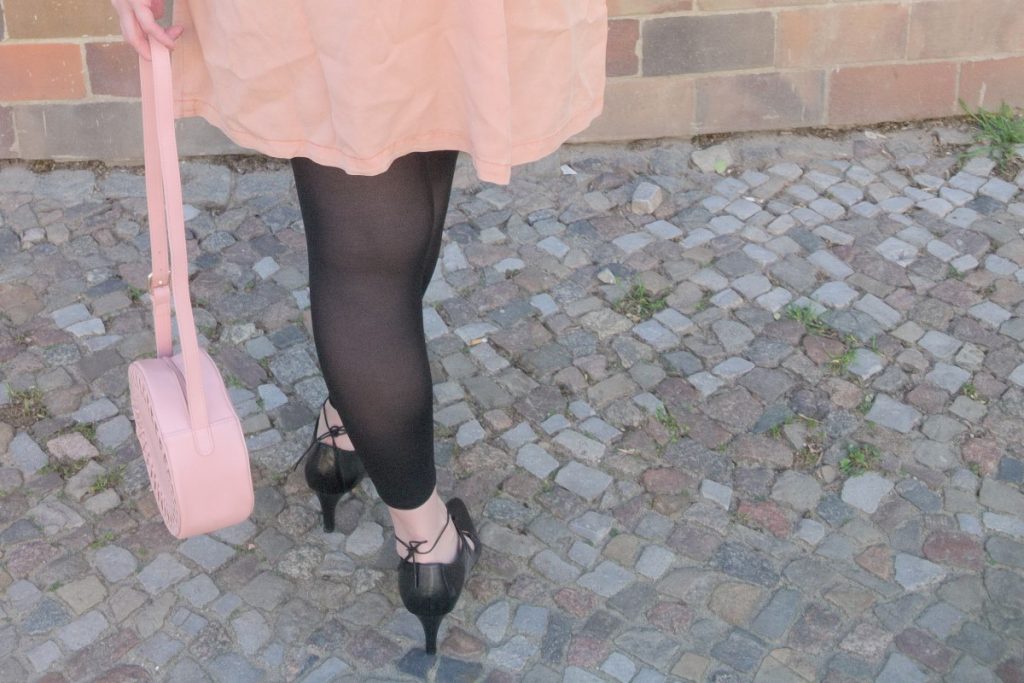 blush and black outfit with pink lyocell dress and round leather bag