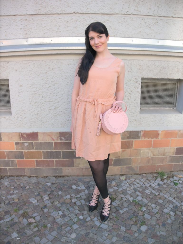 blush and black outfit with pink lyocell dress and round leather bag