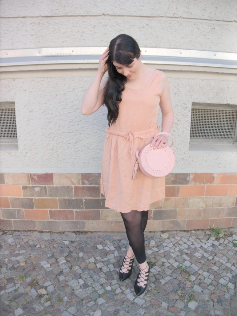 blush and black outfit with pink lyocell dress and round leather bag
