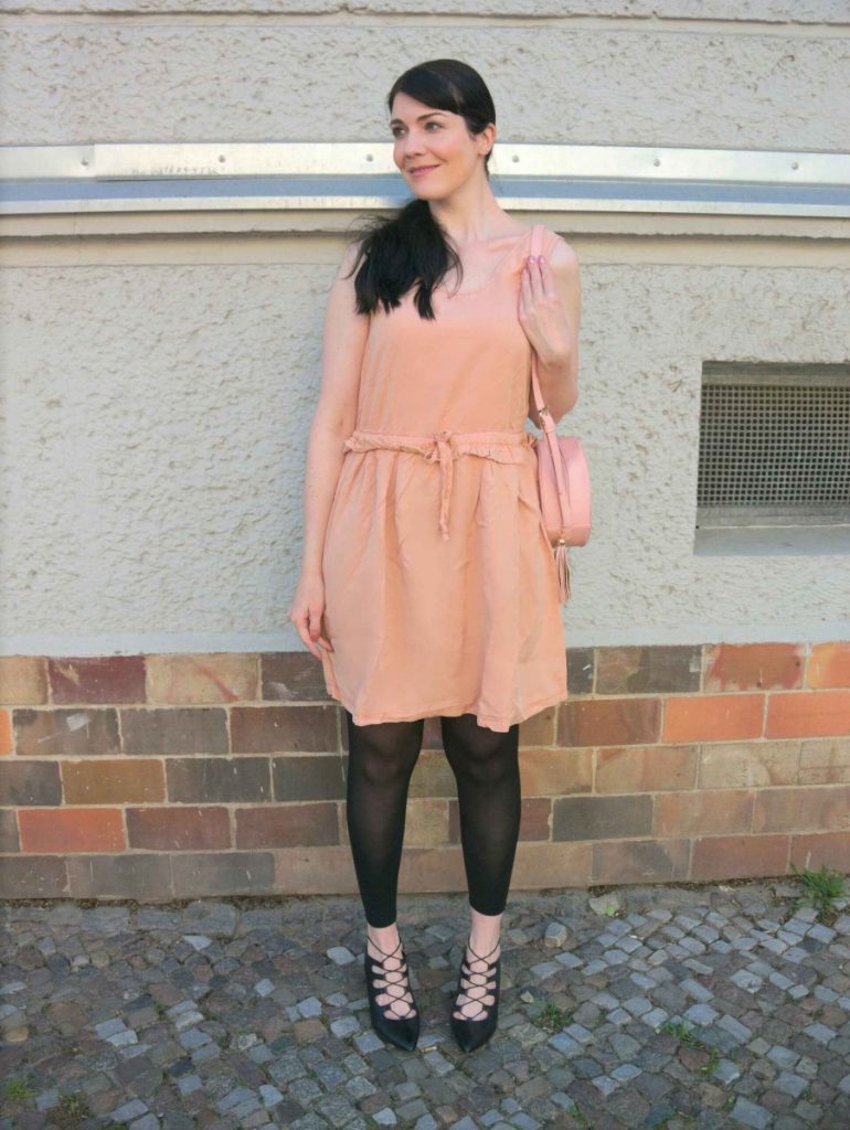 blush and black outfit with pink lyocell dress and round leather bag