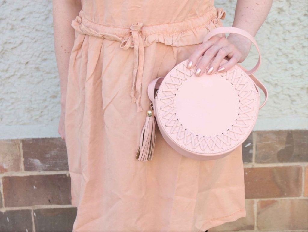 blush and black outfit with pink lyocell dress and round leather bag