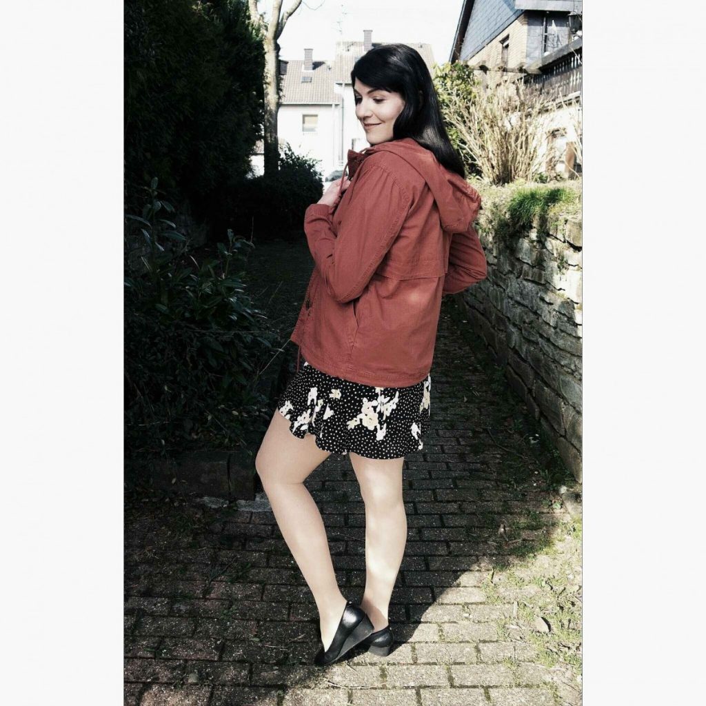 outfit with rust-coloured canvas jacket, floral dress and wedge loafers